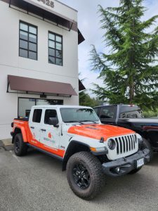 RenoMagic Jeep Gladiator with orange partial commercial wrap and contractor graphics