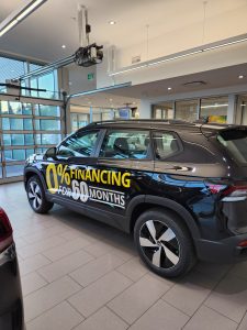 Volkswagen dealership vehicles with custom 0% financing promotional vinyl graphics