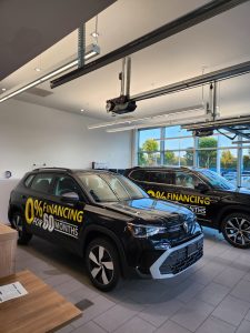 Volkswagen dealership vehicles with custom 0% financing promotional vinyl graphics